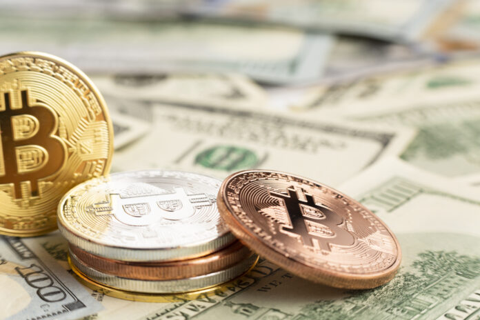 pilha-de-bitcoin-em-cima-de-notas-dolar(1)